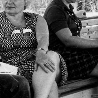 Group of women relaxing outdoors on deck chairs.