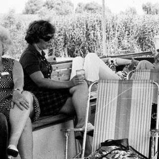Group of women relaxing outdoors on deck chairs.