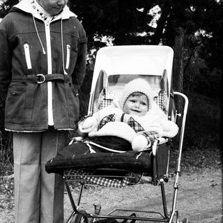 Older child pushing stroller with baby inside.