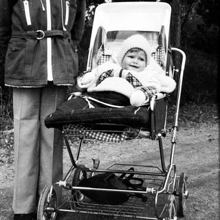 Older child pushing stroller with baby inside.