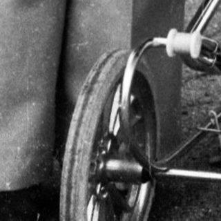 Older child pushing stroller with baby inside.