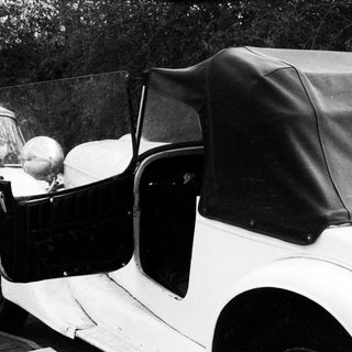 Vintage convertible car with open door.