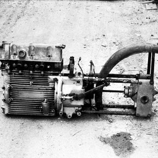 Vintage aircraft engine with propeller and radiator.