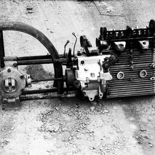 Vintage aircraft engine with propeller and control linkage.