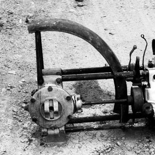 Vintage aircraft engine with propeller and control linkage.