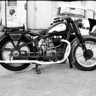 Vintage motorcycle with sidecar, classic engine design.
