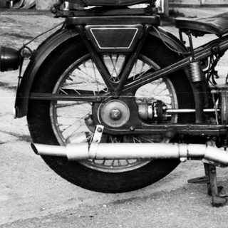 Vintage motorcycle with sidecar, classic engine design.