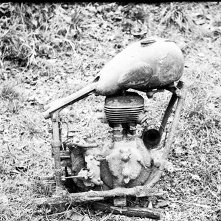 Vintage internal combustion engine on grass.