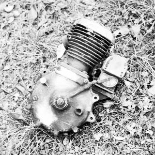 Small airplane engine on grass.