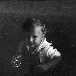 Young child playing with vinyl record.