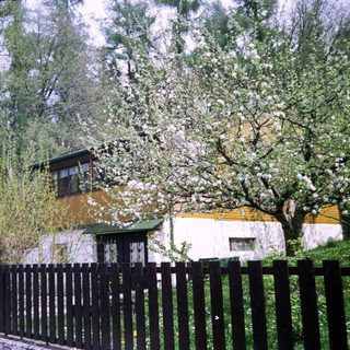 Charming house surrounded by blooming trees.