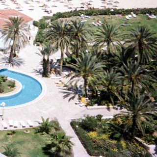 Luxury resort with pools, beach, and ocean.
