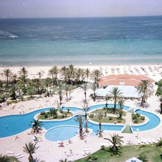 Luxury resort with pools, beach, and ocean.