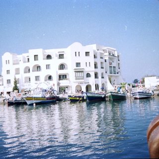 Waterfront buildings with docked boats.