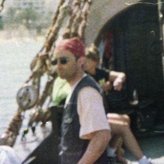 Traditional sailing ship with crew and passengers.