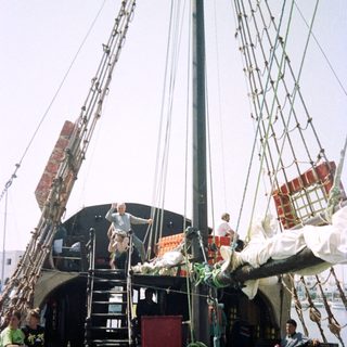 Historic sailing ship with crew aboard.