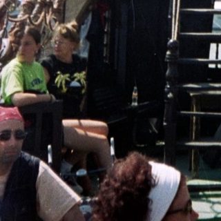 Historic sailing ship with crew aboard.