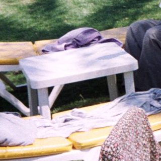 Sunbathing adults at a resort poolside.