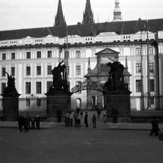 Historic Prague Castle entrance with statues and gates.