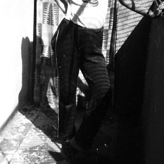 Young boy playing guitar outdoors on stairs.