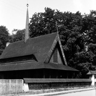 Traditional wooden temple with steep roof and spire.