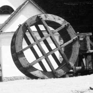 Historic water-powered mill with triangular building.