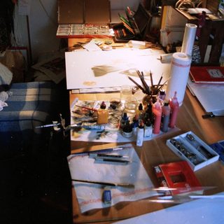Creative workspace cluttered with art supplies.