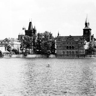 Historic European cityscape with river, bridges, and architecture.