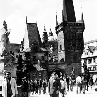 Historic Charles Bridge in Prague with medieval architecture.