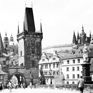 Historic Prague Charles Bridge with statues and towers.