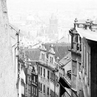 Narrow European street with historic buildings.