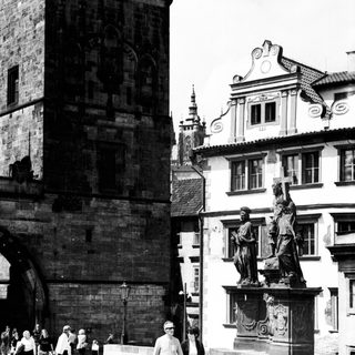 Historic European square with Gothic architecture and statue.