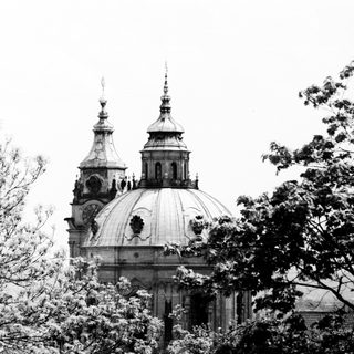 Baroque-style church with twin domes and spires.