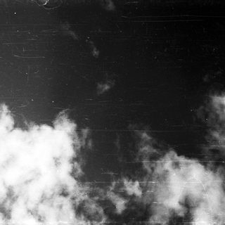 Dark sky with scattered, dense clouds.