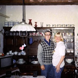 Two people standing in a vintage kitchen with retro decor.