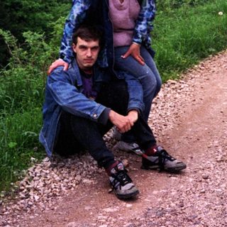 Two people hiking on scenic mountain trail.