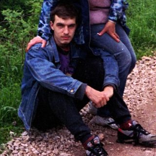 Two people hiking on scenic mountain trail.