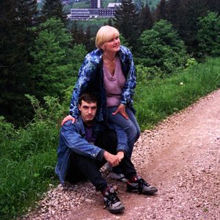 Two people hiking on scenic mountain trail.