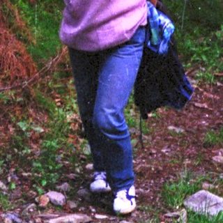Woman hiking on a forest trail.