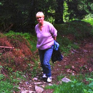 Woman hiking on a forest trail.