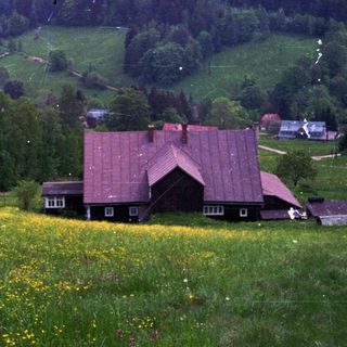 Rural village nestled in green mountain valley.