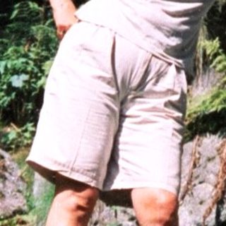 Woman posing confidently on rocky trail.