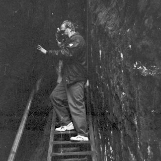 Person taking photo on wet stairs.