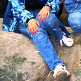 Two people sitting on rocks in a cave.