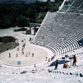 Ancient Greek-style amphitheater with seating and stage.