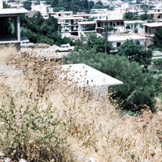 Hilly residential area with scattered houses.