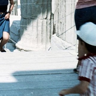 Group of people walking on ancient ruins.