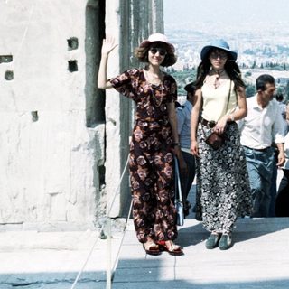Group of people walking on ancient ruins.