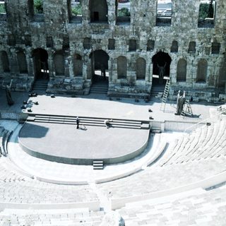 Ancient Roman amphitheater interior with tiered seating.