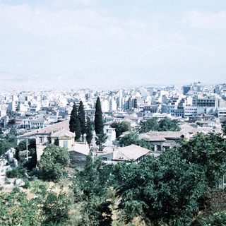Urban landscape with historic ruins and greenery.